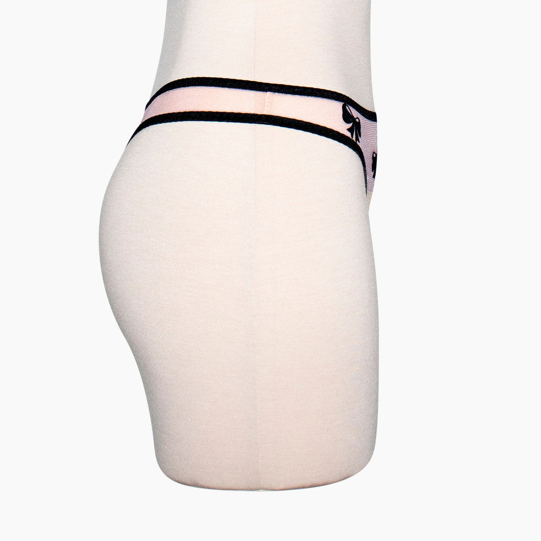Peach sheer mesh thong with black velvet bow applique