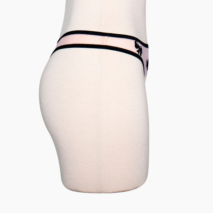 Peach sheer mesh thong with black velvet bow applique