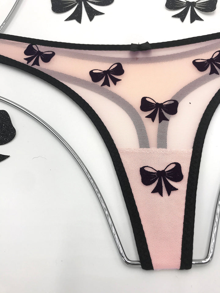 Peach sheer mesh thong with black velvet bow applique